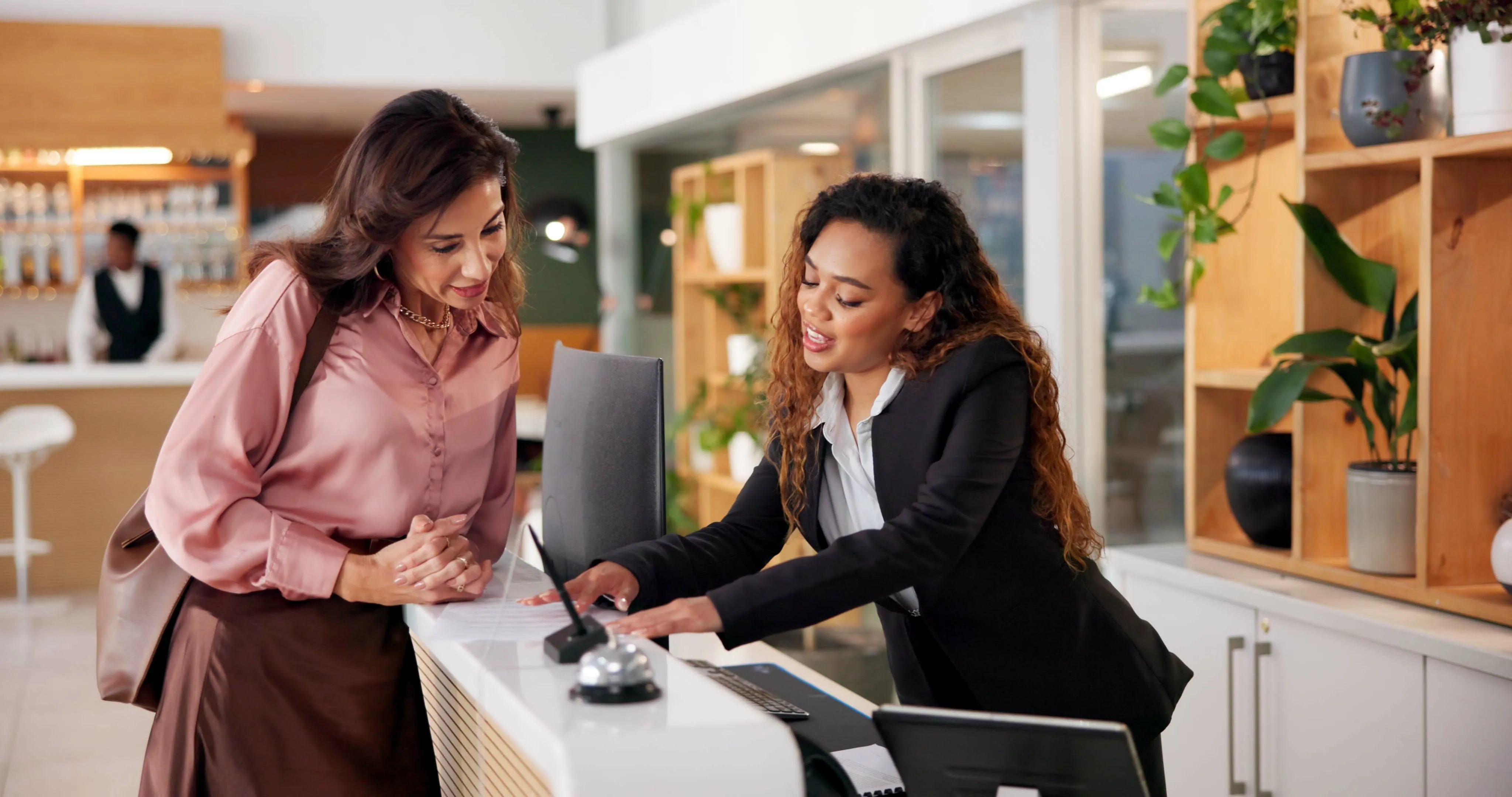 Hotel front desk staff welcoming guests