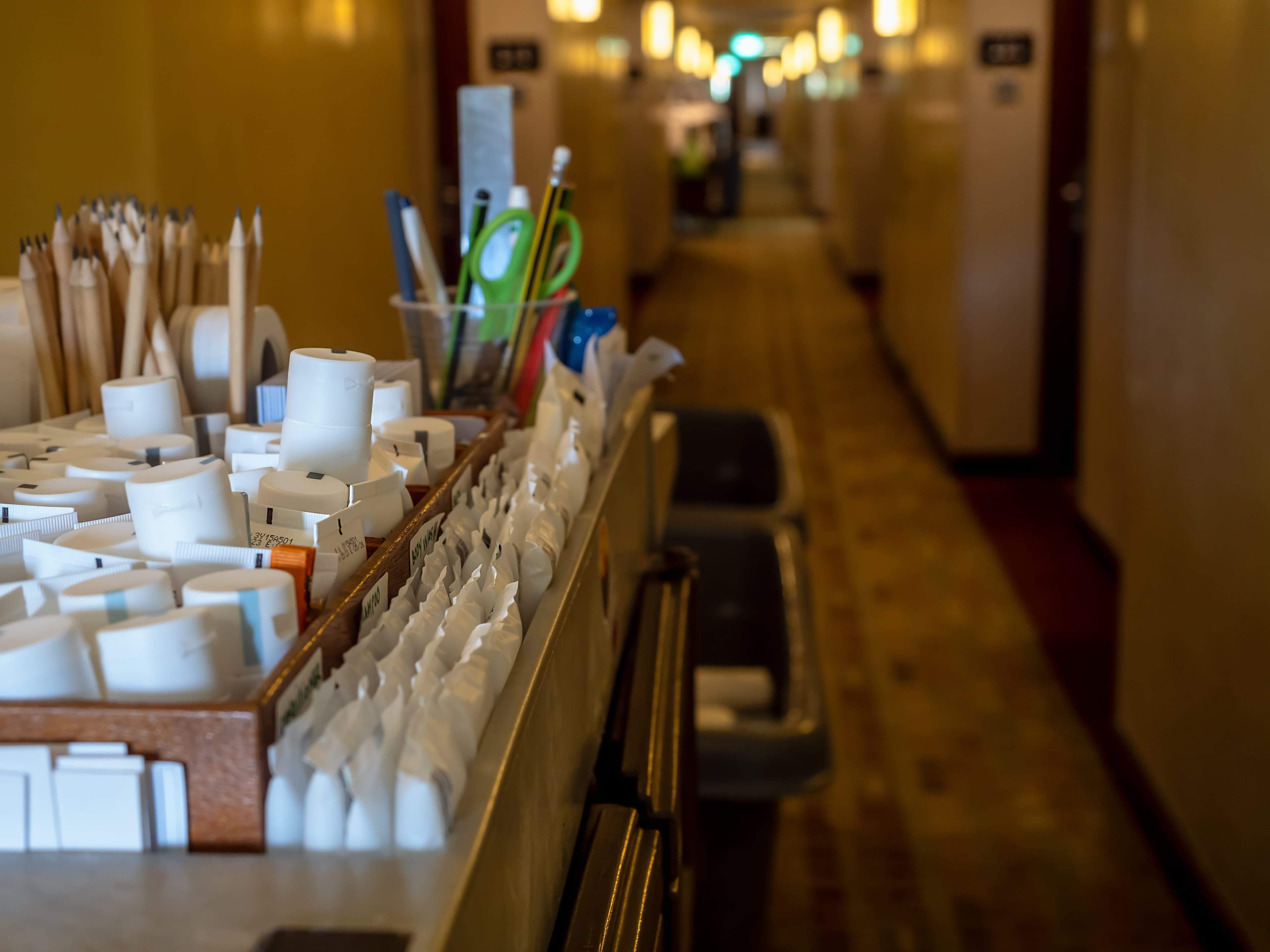 Full housekeeping cart in an empty hallway